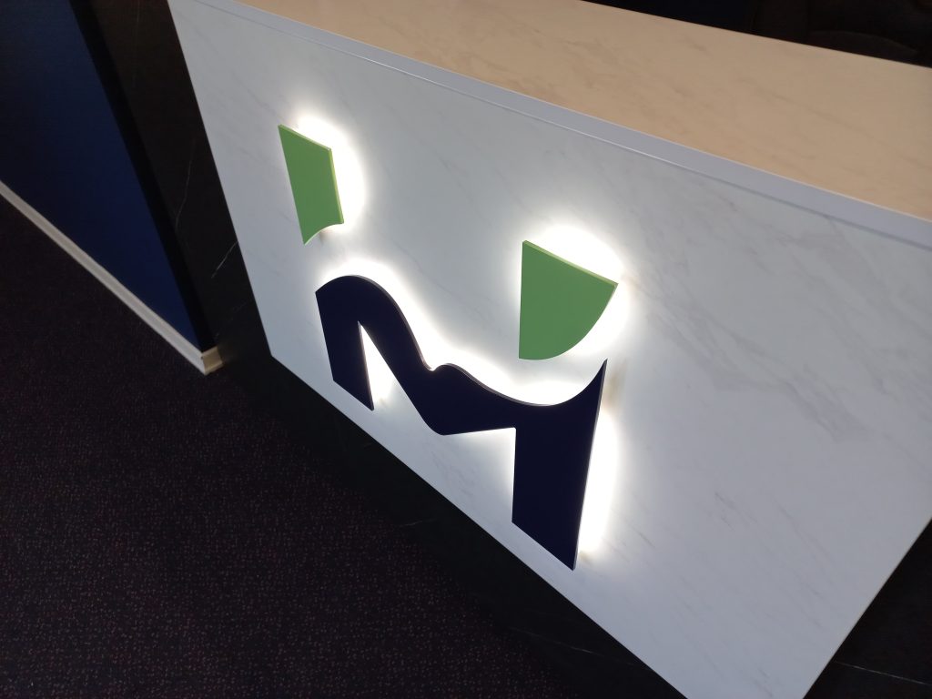 Motion Health Logo Halo Backlit Signage Reception Desk